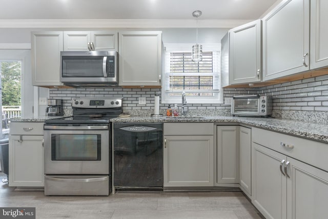 kitchen with a sink, stainless steel appliances, backsplash, and a healthy amount of sunlight