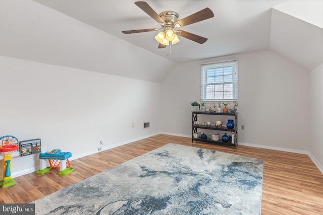 bonus room with visible vents, light wood-type flooring, baseboards, and vaulted ceiling