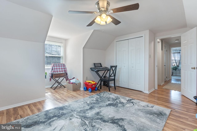 playroom featuring ceiling fan, baseboards, lofted ceiling, and wood finished floors