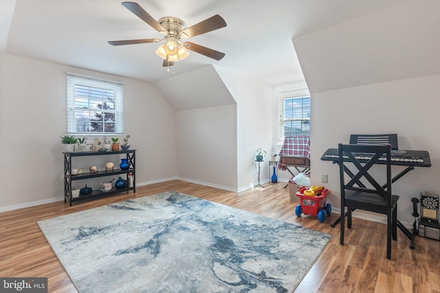 sitting room with lofted ceiling, wood finished floors, baseboards, and ceiling fan