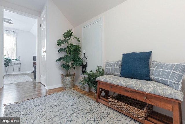 sitting room with lofted ceiling, wood finished floors, and baseboards