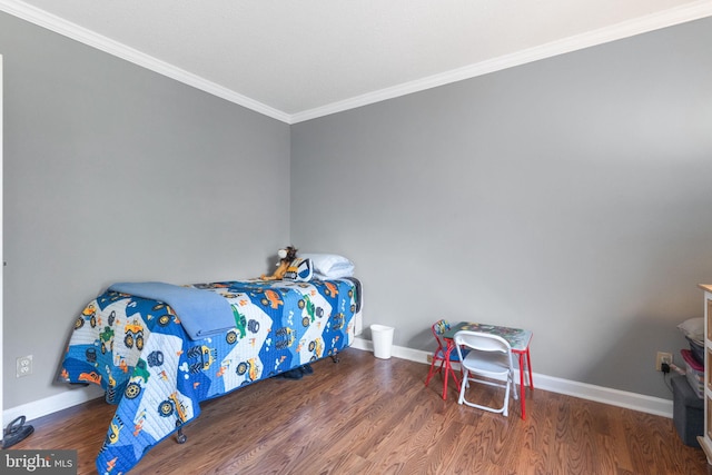 bedroom with baseboards, wood finished floors, and crown molding