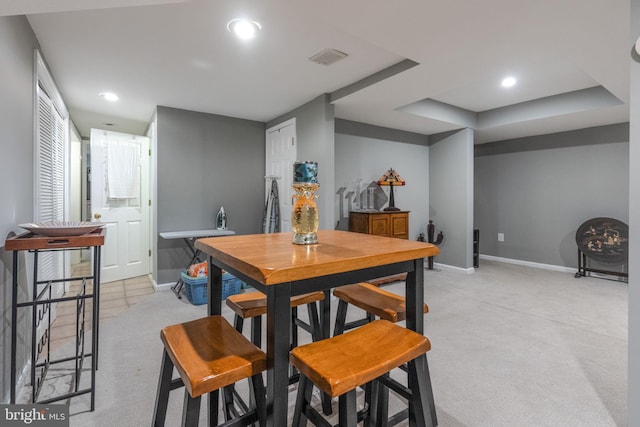 dining room featuring recessed lighting, baseboards, and light colored carpet