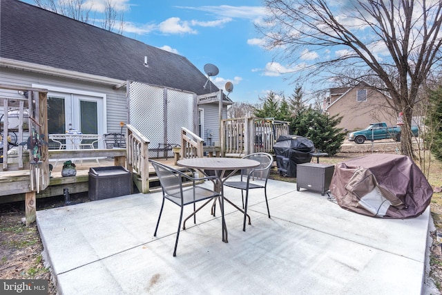 view of patio with outdoor dining area, french doors, grilling area, and a wooden deck