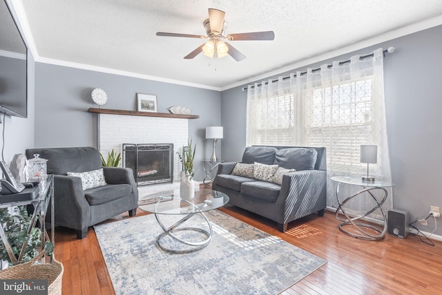 living room with a textured ceiling, crown molding, and hardwood / wood-style flooring