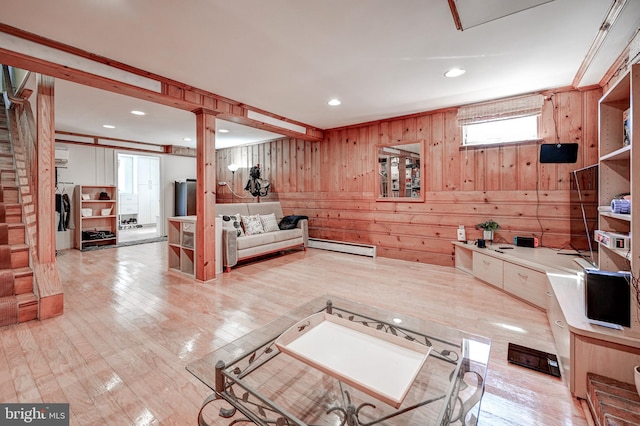 interior space with a baseboard radiator, light countertops, wood walls, light wood-style floors, and recessed lighting