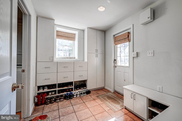 mudroom featuring a healthy amount of sunlight and light tile patterned floors