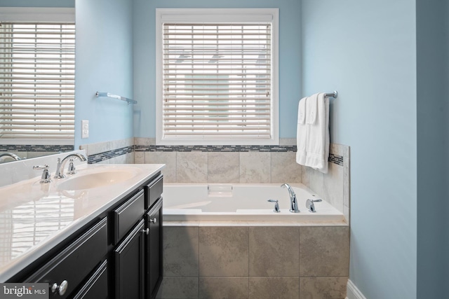 full bathroom featuring a bath and vanity