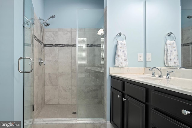 bathroom with a stall shower and vanity