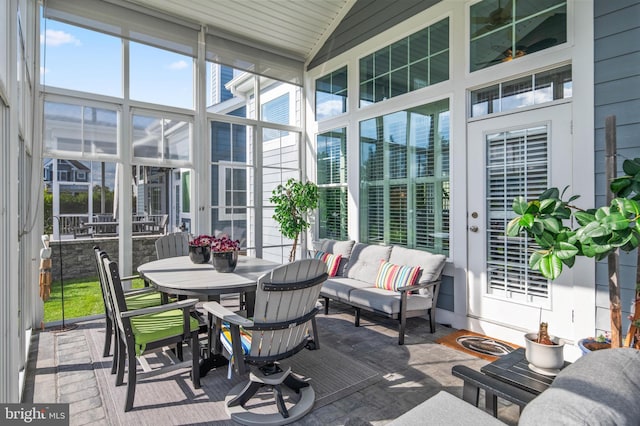 sunroom with lofted ceiling and a healthy amount of sunlight