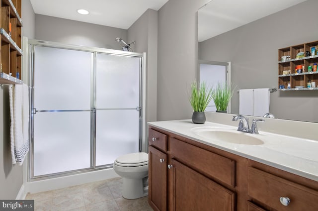 bathroom with tile patterned flooring, toilet, a shower stall, and vanity