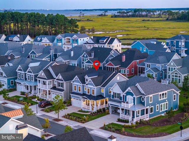 drone / aerial view featuring a water view and a residential view