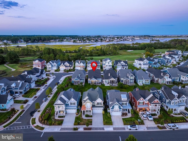 drone / aerial view with a residential view and a water view