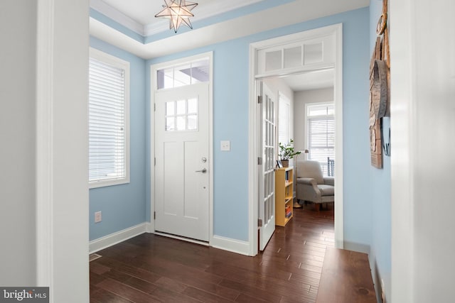 foyer with dark wood-style floors and baseboards