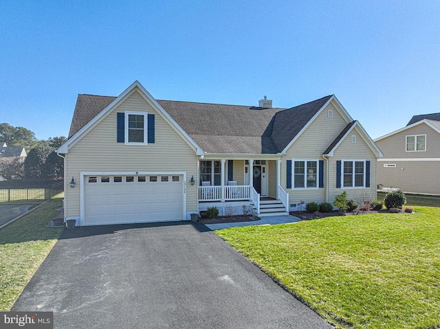 traditional-style house with driveway, an attached garage, covered porch, a chimney, and a front lawn