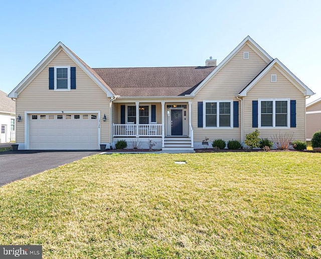 view of front facade featuring aphalt driveway, a porch, an attached garage, a front yard, and a chimney