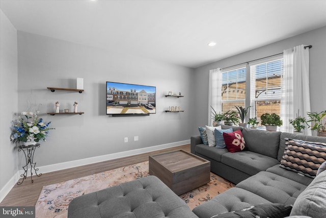 living room featuring recessed lighting, wood finished floors, and baseboards