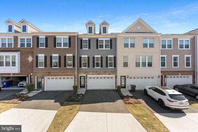 townhome / multi-family property featuring a garage and driveway