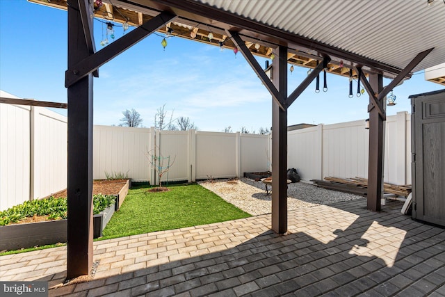 view of patio / terrace with a fenced backyard and a garden