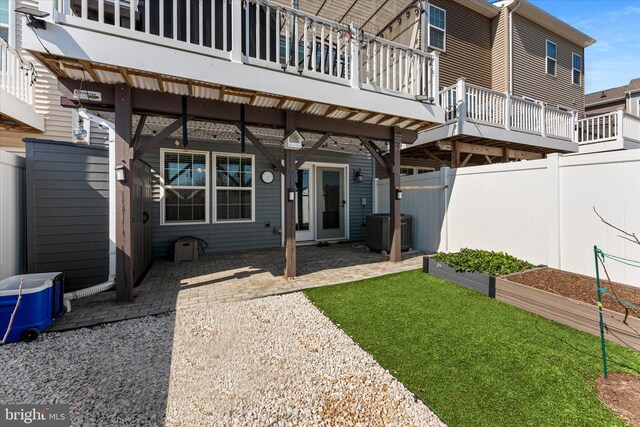 exterior space featuring fence, cooling unit, a yard, a garden, and a patio area