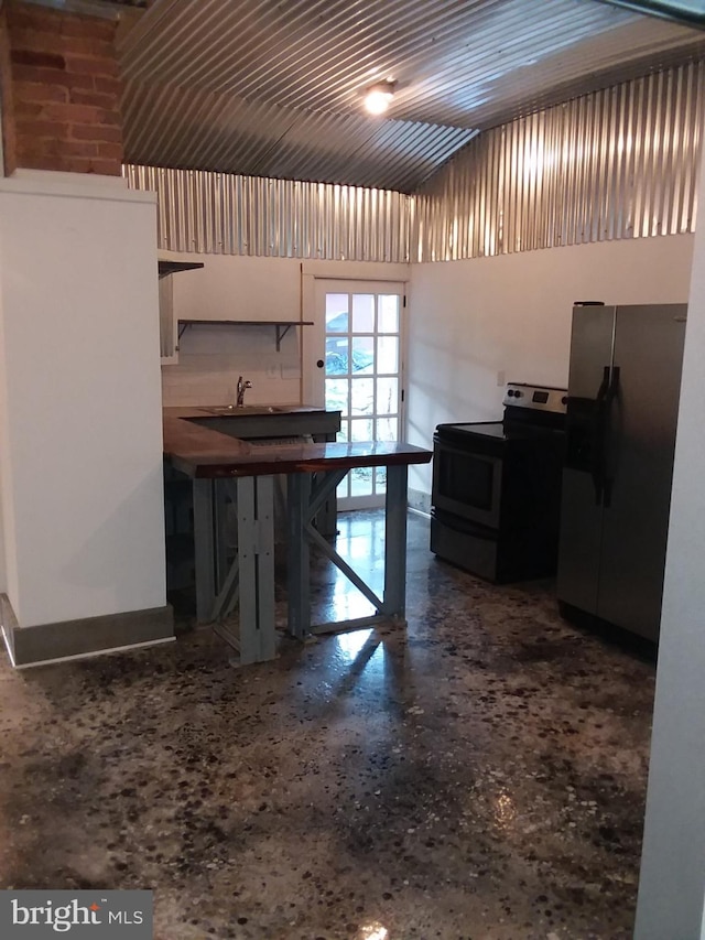 kitchen with speckled floor and appliances with stainless steel finishes