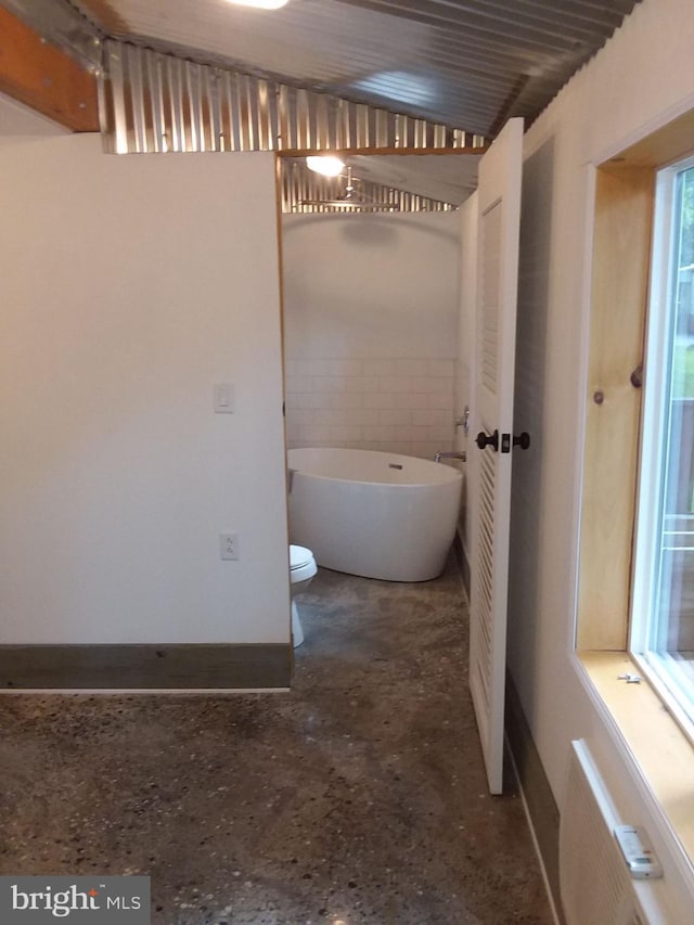 bathroom with a soaking tub