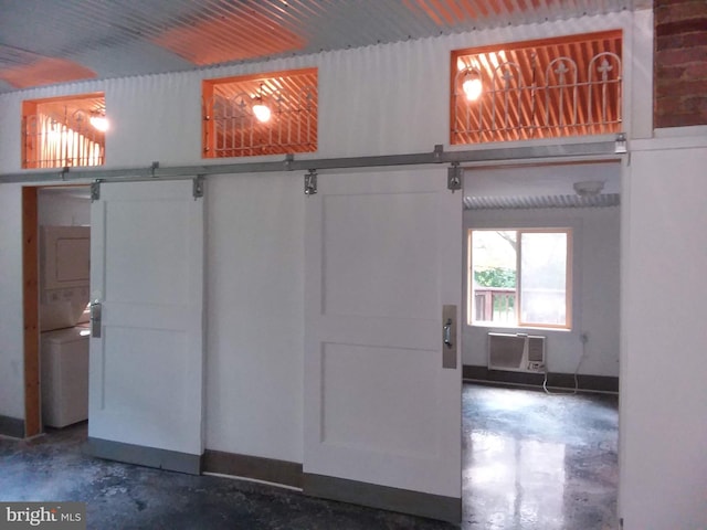 interior space featuring baseboards and a wall unit AC