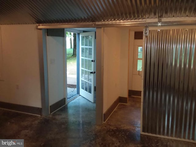 entryway featuring baseboards and concrete flooring