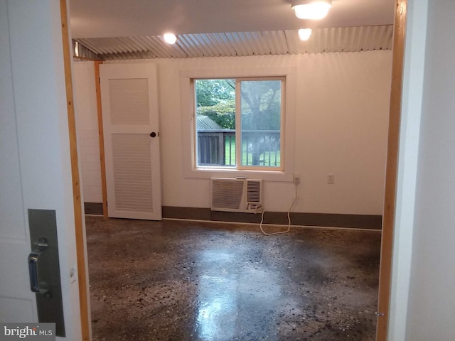 empty room featuring concrete floors and a wall mounted AC