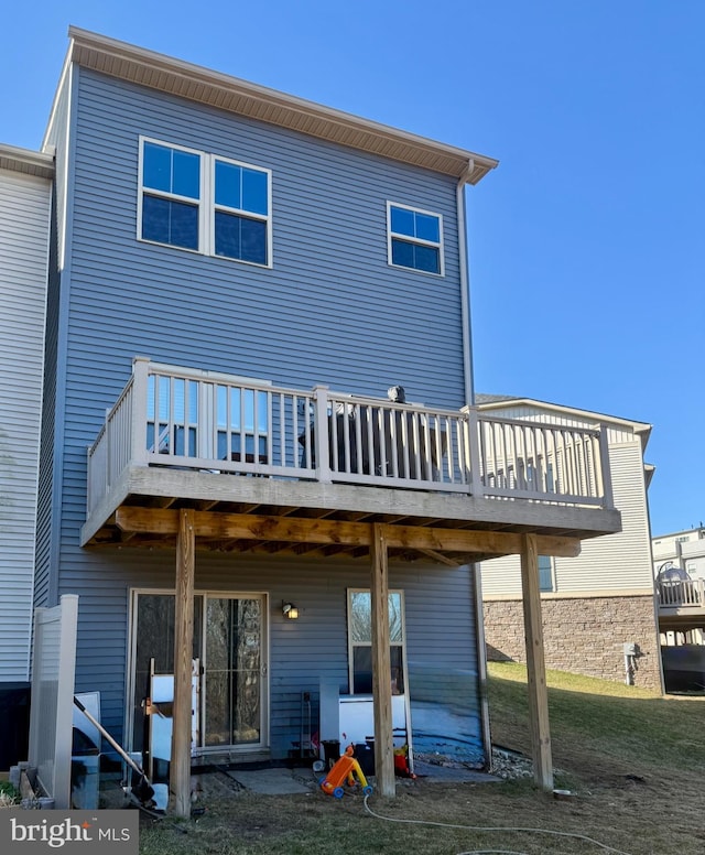 back of house with a wooden deck