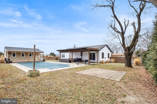 back of property featuring an outbuilding, a patio area, a yard, and a fenced backyard