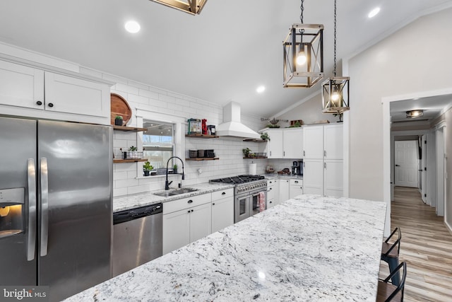 kitchen featuring appliances with stainless steel finishes, custom range hood, a sink, and open shelves