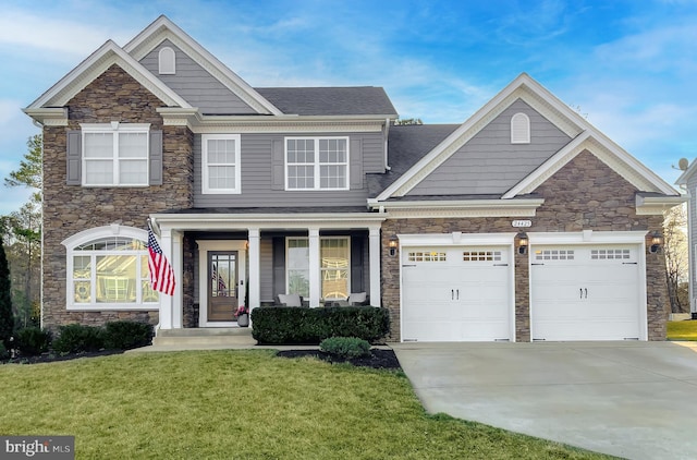 craftsman-style house with a front lawn, a porch, concrete driveway, an attached garage, and a shingled roof