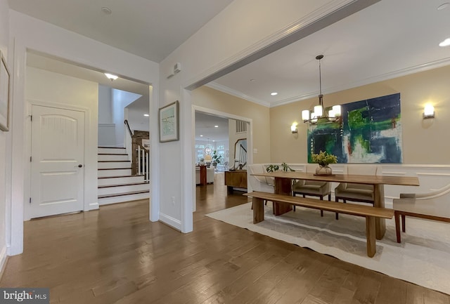 dining room featuring stairway, ornamental molding, recessed lighting, an inviting chandelier, and wood finished floors