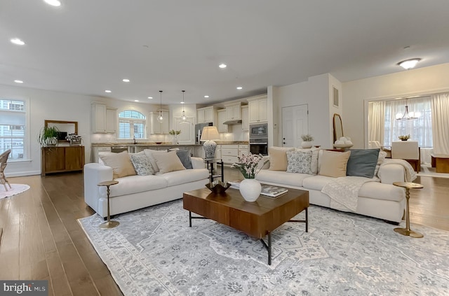 living area featuring light wood-style floors and a healthy amount of sunlight