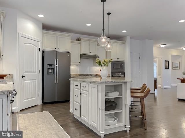 kitchen featuring under cabinet range hood, open shelves, a kitchen island, stainless steel appliances, and dark wood-style flooring