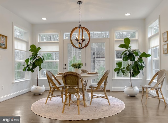 sunroom with plenty of natural light and a notable chandelier