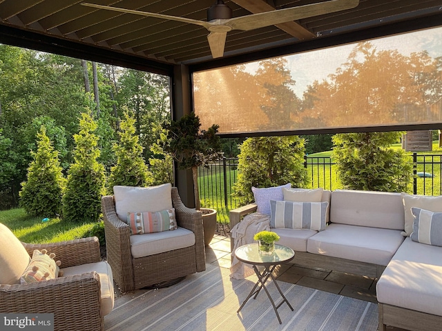 wooden terrace featuring a patio, outdoor lounge area, a ceiling fan, and fence