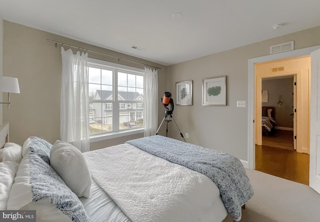 bedroom with visible vents and baseboards