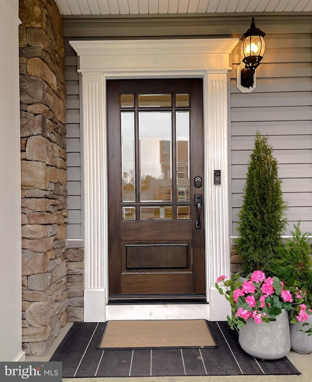 property entrance featuring stone siding