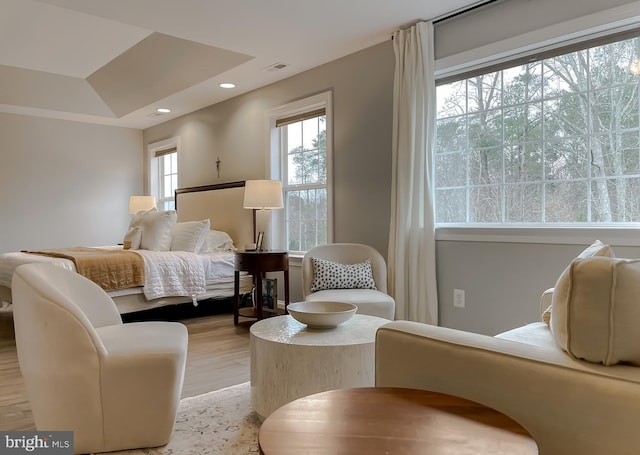 bedroom featuring light wood finished floors, visible vents, and recessed lighting