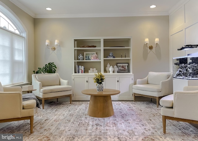 living area with recessed lighting and ornamental molding