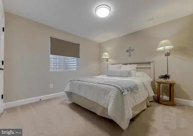 carpeted bedroom featuring visible vents and baseboards