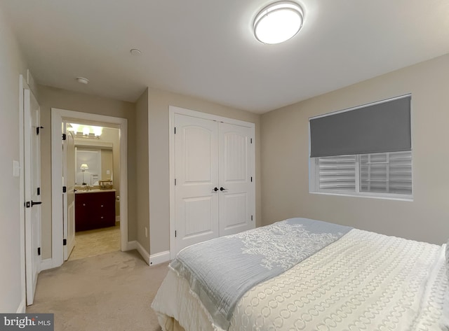 bedroom with light colored carpet, a closet, and baseboards