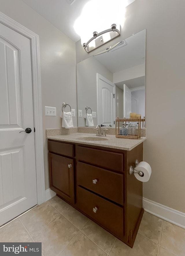 bathroom featuring tile patterned floors, baseboards, and vanity