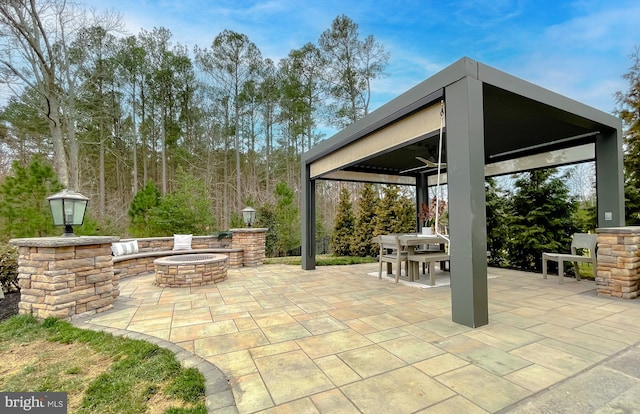 view of patio featuring outdoor dining space, a gazebo, and an outdoor fire pit