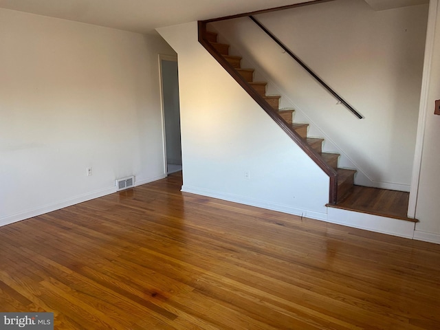 interior space featuring visible vents, baseboards, and wood finished floors