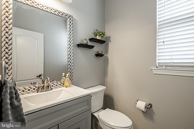 half bathroom with toilet and vanity