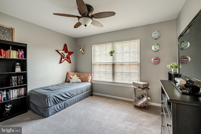 carpeted bedroom featuring a ceiling fan and baseboards