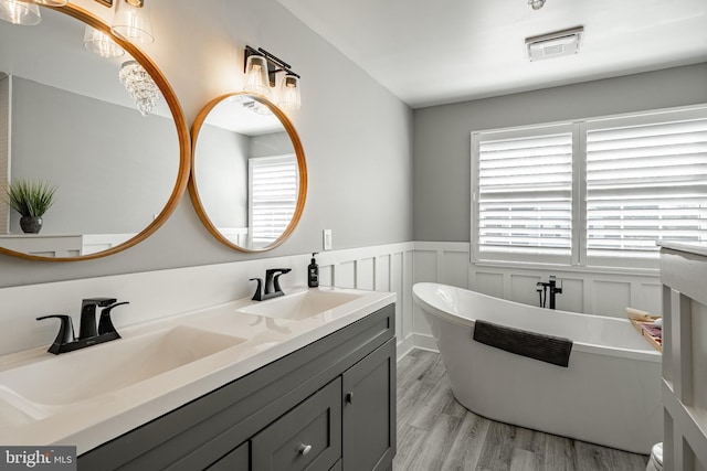 bathroom featuring a wealth of natural light, visible vents, and a sink